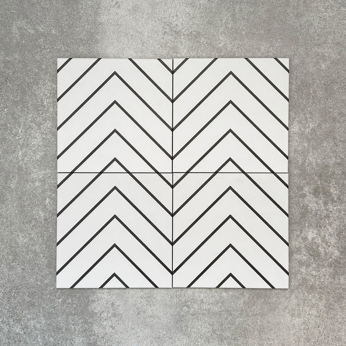 Four Almeria Jilani White Moroccan-style porcelain wall and floor tiles displayed together in a clean black line chevron pattern on a white base, 20x20cm.