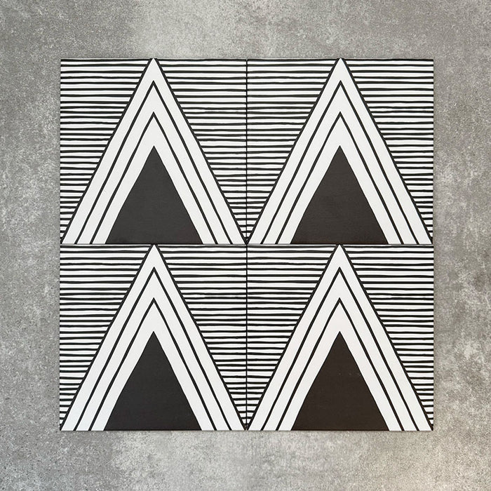 Four Almeria Giza Moroccan-style porcelain wall and floor tiles displayed together in a bold black and white geometric triangle pattern, 20x20cm.