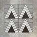 Four Almeria Giza Moroccan-style porcelain wall and floor tiles displayed together in a bold black and white geometric triangle pattern, 20x20cm.