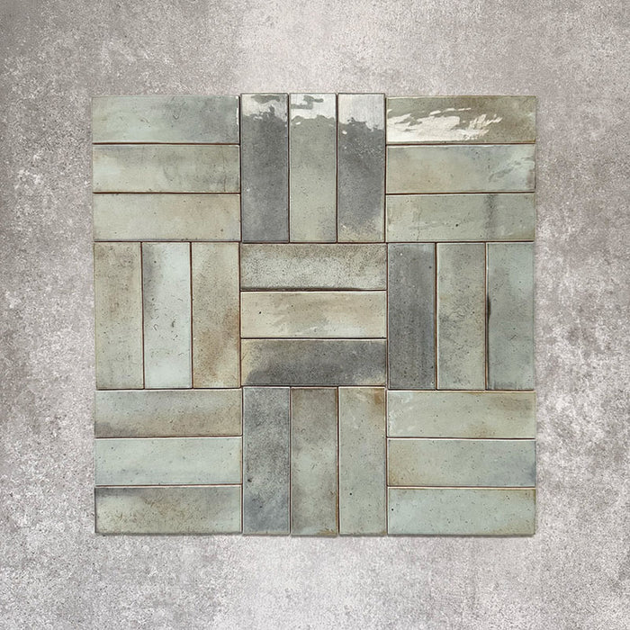 Saigon Celadon Green Brick Wall tiles arranged in a basketweave pattern, featuring Moroccan-style 5.1 × 16.1cm glossy ceramic tiles with soft green and blue-grey tonal variation.
