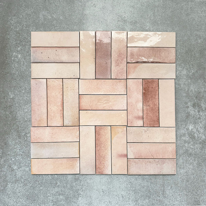 Saigon Rose Pink Brick Wall tiles arranged in a basketweave pattern, featuring Moroccan-style 5.1 × 16.1cm glossy ceramic tiles in soft blush and rose tones with natural colour variation.