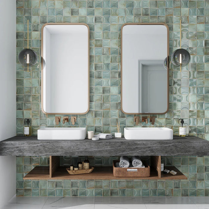Bathroom featuring Saigon Celadon Green Decor Square Wall tiles in a Moroccan-inspired style, 10 × 10cm glossy ceramic tiles in soft green and blue tones with a decorative relief pattern, paired with a double vanity and wall-mounted mirrors.