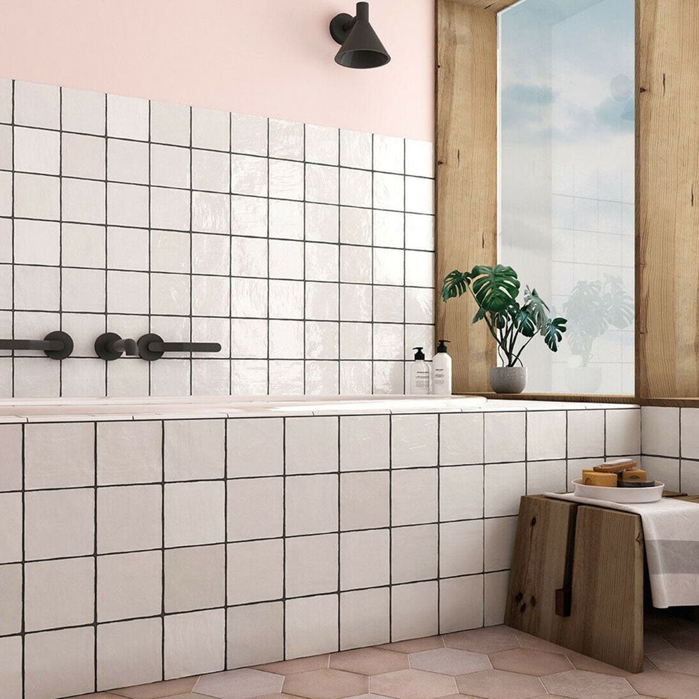 Zellige White square tiles installed in a bathroom, featuring a glossy white finish with visible grout lines and subtle surface variation.