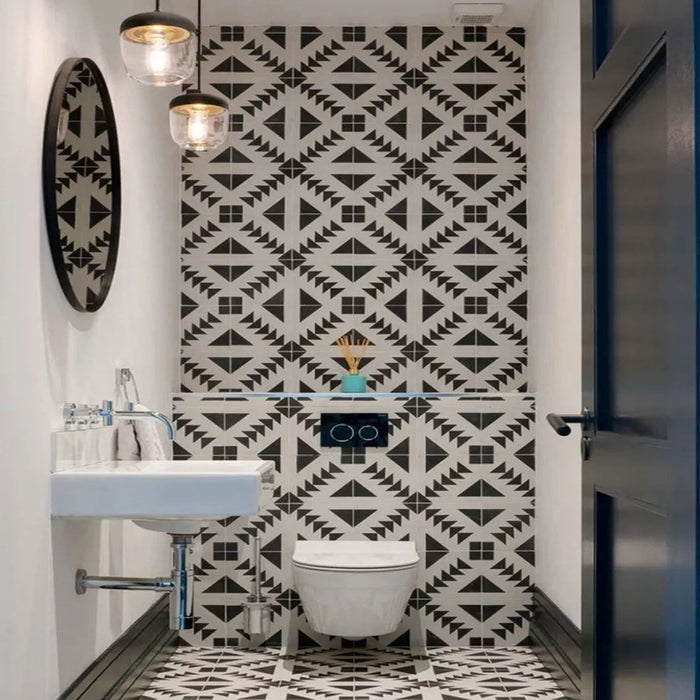 Almeira Azteca Moroccan-style porcelain tiles in a compact bathroom, featuring a bold black and white geometric pattern used on both the wall and floor to create a striking, coordinated look, 20x20cm.