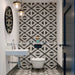 Almeira Azteca Moroccan-style porcelain tiles in a compact bathroom, featuring a bold black and white geometric pattern used on both the wall and floor to create a striking, coordinated look, 20x20cm.