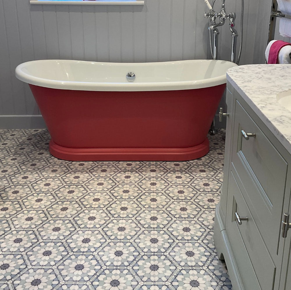 Bathroom featuring Medina Frost Blue Moroccan-style hexagon porcelain floor tiles, 18.7 × 21.6 cm, laid in a repeating geometric pattern and paired with a freestanding bath and classic cabinetry.