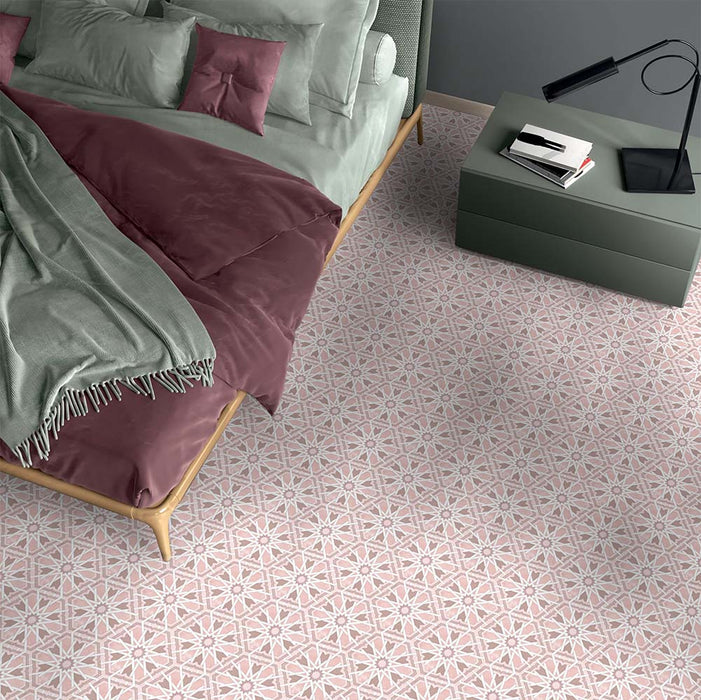 Bedroom featuring Medina Hormuz Rose Moroccan-style hexagon porcelain floor tiles, 18.7 × 21.6 cm, laid in a star-inspired geometric pattern and styled with soft pink bedding and contemporary furniture.