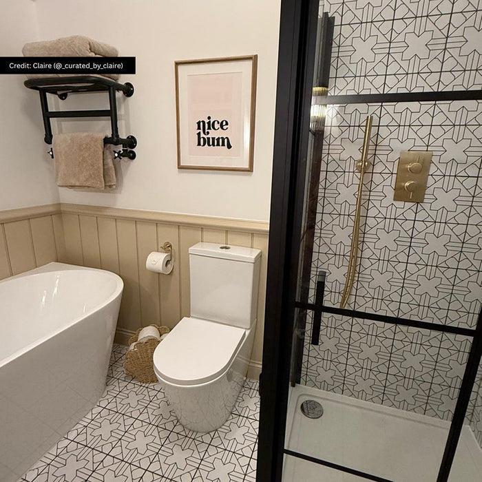 Bathroom featuring Almeria Palace Moroccan-style porcelain wall and floor tiles in a refined black and white geometric pattern, 20x20cm, paired with brass fixtures and neutral finishes.