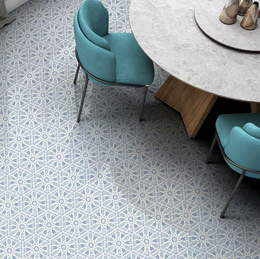 Dining area featuring Medina Hormuz Azure Blue Moroccan-style hexagon porcelain floor tiles, 18.7 × 21.6 cm, laid in a striking star-inspired geometric pattern and paired with contemporary furniture for a modern look.