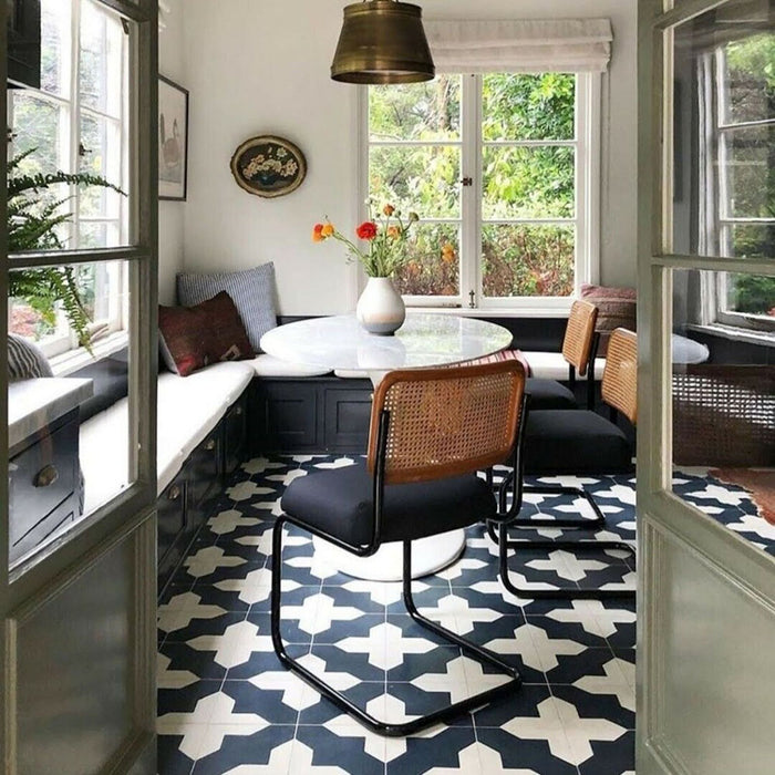 Dining area featuring Almeria Cathedral Moroccan-style porcelain floor tiles in a bold black and white geometric pattern, 20x20cm, adding character and contrast to the space.