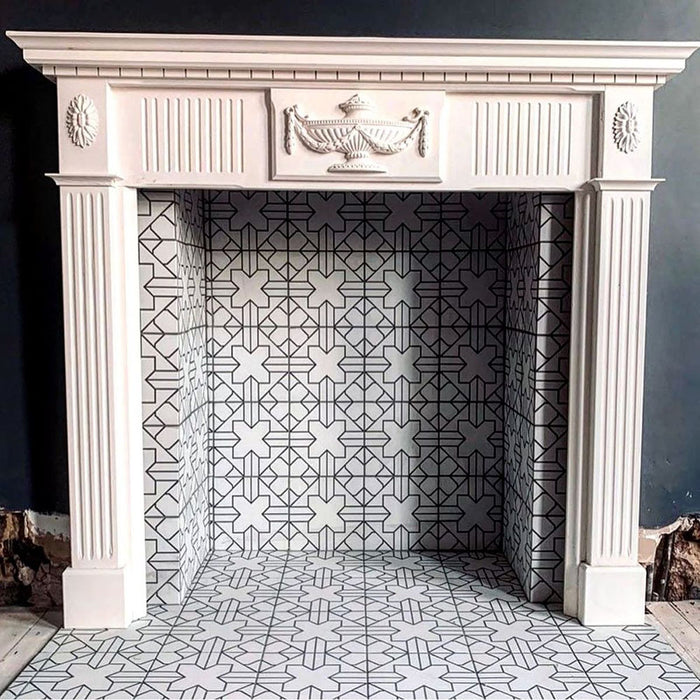 Fireplace surround featuring Almeria Palace Moroccan-style porcelain wall and floor tiles in a refined black line geometric pattern, 20x20cm, creating an elegant and timeless focal point.