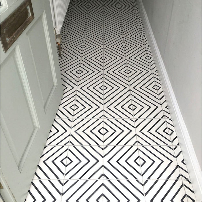 Hallway floor featuring Almeria Jilani White Moroccan-style porcelain tiles in a bold black line geometric diamond pattern, 20x20cm, creating a striking monochrome walkway.