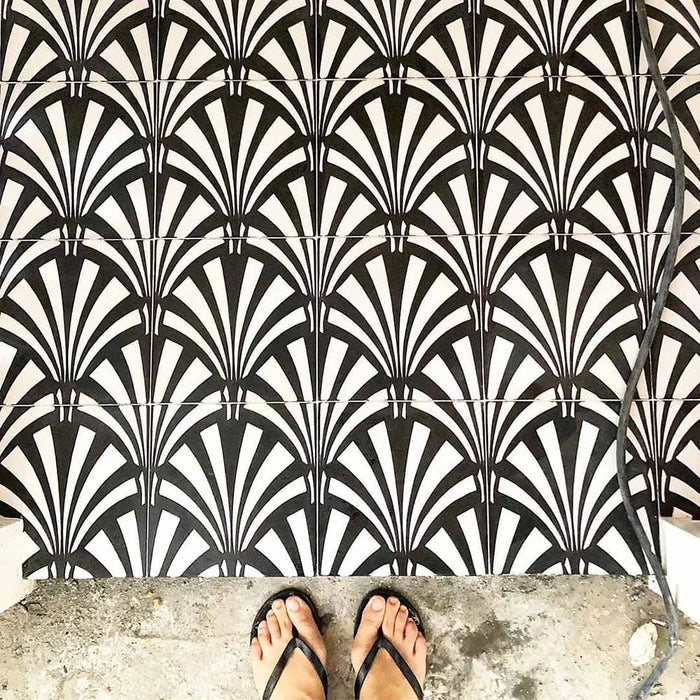 Floor featuring Almeria Casablanca Moroccan-style porcelain tiles in a bold black and white fan pattern, 20x20cm, creating a striking and decorative tiled surface.