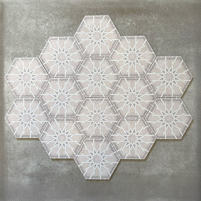 Grouped layout of Medina Hormuz Snow White Moroccan-style hexagon porcelain tiles, 18.7 × 21.6 cm, showcasing the full repeating star-inspired geometric pattern in white and soft grey tones on a neutral background.