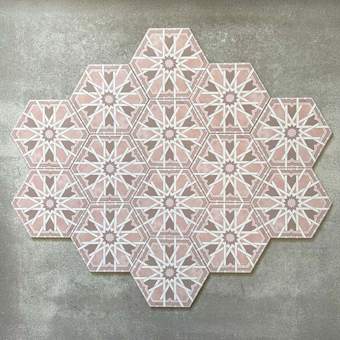 Grouped layout of Medina Hormuz Rose Moroccan-style hexagon porcelain tiles, 18.7 × 21.6 cm, showcasing the full repeating star-inspired geometric pattern in soft rose and white tones on a neutral background.