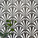 Almeria Casablanca Moroccan-style porcelain wall and floor tiles arranged in a repeating black and white fan pattern, 20x20cm, styled with greenery for a decorative display.