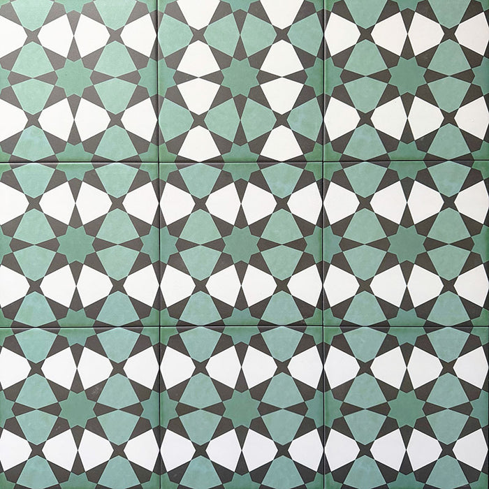 Group of Agadir Verde Moroccan-style 20x20cm porcelain tiles laid together, showcasing a repeating geometric star pattern in green, white and charcoal tones.