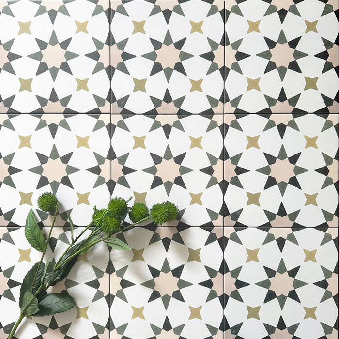 Group image of Agadir Natural Moroccan-style 20x20cm porcelain tiles, showcasing a repeating geometric star pattern in soft white with muted beige, olive and charcoal tones, styled with green foliage for a natural look.