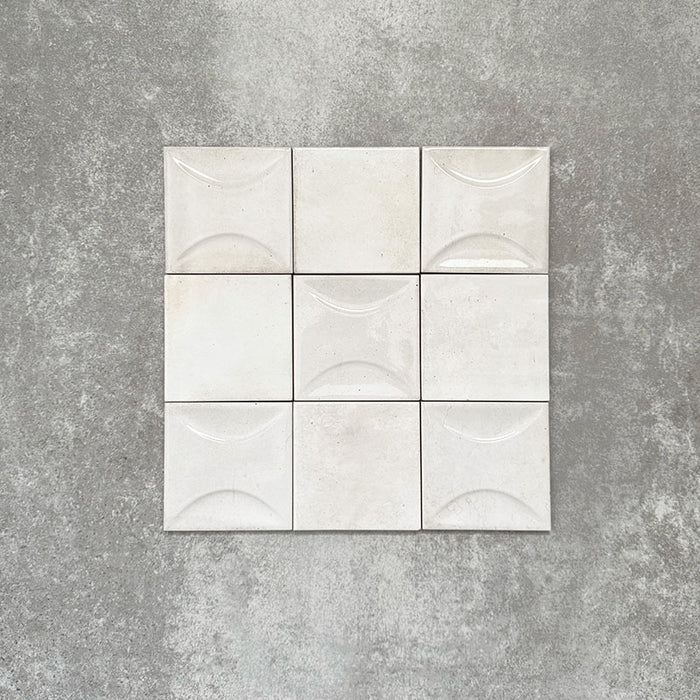 Saigon White Square Wall tiles shown in a grouped layout, featuring Moroccan-style 10 × 10cm glossy ceramic tiles in soft white tones with subtle surface texture and tonal variation.