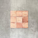 Close-up of Saigon Rose Pink Decor Square Wall tiles, featuring Moroccan-style 10 × 10cm glossy ceramic tiles in soft blush and rose tones with a curved decorative relief pattern.