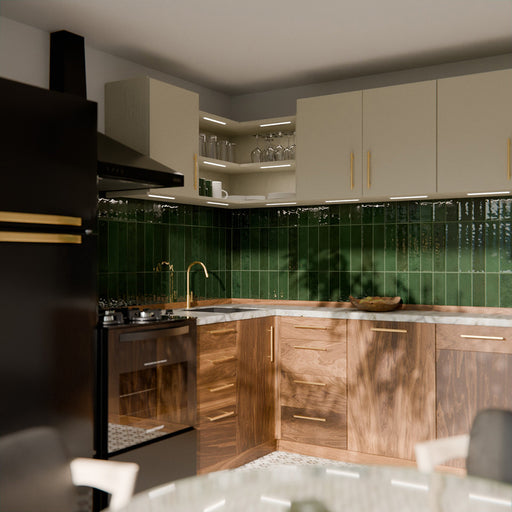 Gloss moss green Nairobi handmade-effect tiles shown in a kitchen setting, highlighting the rich colour depth and lightly textured glazed surface alongside natural wood units and brass details.