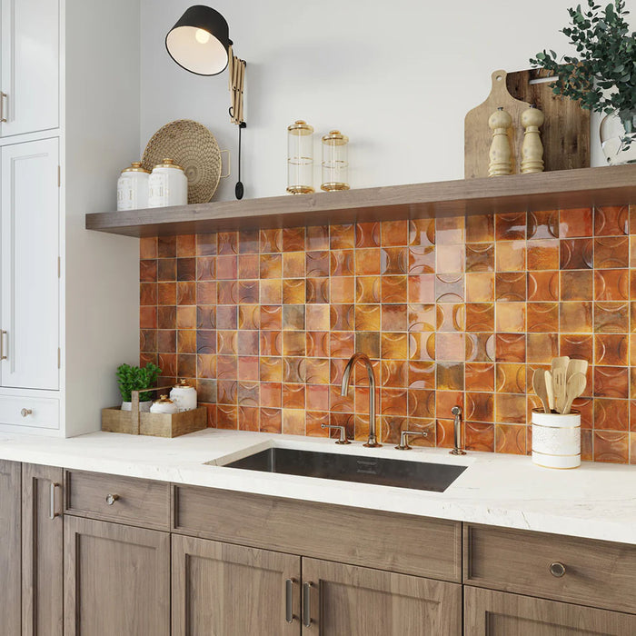 Kitchen splashback featuring Saigon Amber Decor Square Wall tiles in a Moroccan-inspired style, 10 × 10cm glossy ceramic tiles in warm amber tones, paired with wooden cabinetry and open shelving.