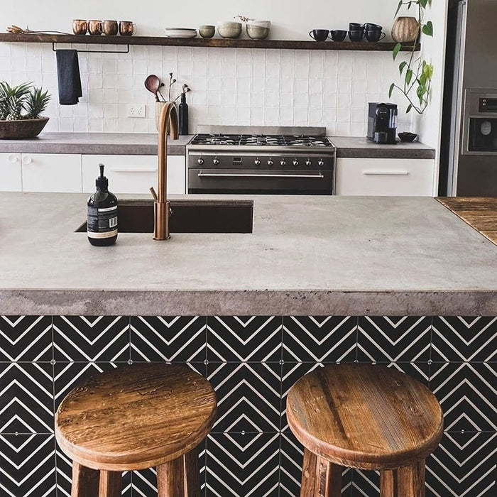 Kitchen island featuring Almeria Jilani Black Moroccan-style porcelain tiles in a striking white line geometric chevron pattern, 20x20cm, adding contrast and character to the space.