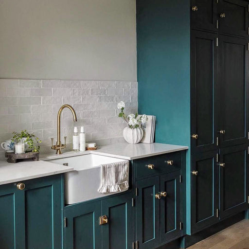 Kitchen featuring Zellige Oyster Brick Moroccan-style ceramic wall tiles in a 6.5 × 20cm brick format, laid in a horizontal pattern as a splashback and paired with deep green cabinetry, brass fixtures and light worktops for a warm, characterful kitchen finish.
