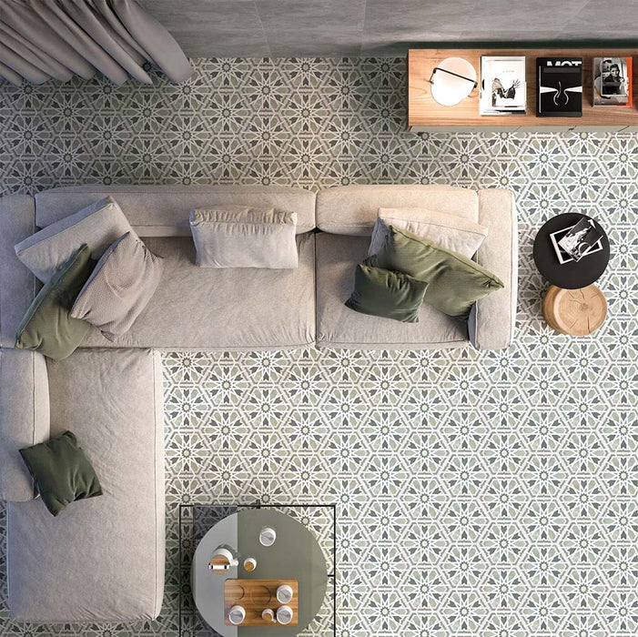 Living room featuring Medina Hormuz Sage Green/Grey Moroccan-style hexagon porcelain floor tiles, 18.7 × 21.6 cm, laid in a striking geometric pattern and styled with modern seating and soft neutral furnishings.