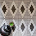 Almeria Giza Moroccan-style porcelain wall and floor tiles laid in a repeating black and white geometric triangle pattern, 20x20cm, creating a bold and decorative tiled surface.