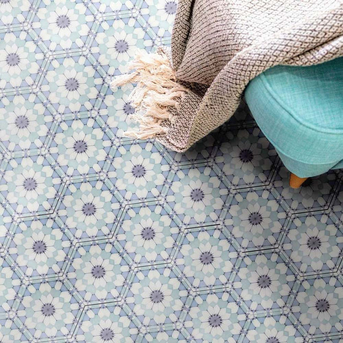 Living space featuring Medina Frost Blue Moroccan-style hexagon porcelain floor tiles, 18.7 × 21.6 cm, laid in a repeating geometric pattern and styled with soft furnishings for a calm, contemporary look.