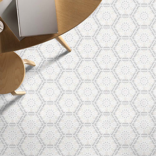 Living space featuring Medina Hormuz Snow White Moroccan-style hexagon porcelain floor tiles, 18.7 × 21.6 cm, laid in a crisp star-inspired geometric pattern and styled with light wood furniture for a clean, modern look.