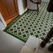 Greenbrook Manor anti-slip encaustic Victorian-style porcelain tiles laid in a traditional hallway, featuring a repeating geometric pattern in green, black and white with a decorative border framing the floor.