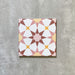 Agadir Springs Moroccan-style 20x20cm porcelain tile featuring a geometric star pattern in soft terracotta, blush pink, white and warm yellow tones, shown as a single tile on a neutral background.