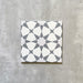 Single Agadir Silver Moroccan-style 20x20cm porcelain tile, featuring a geometric star pattern in soft silver and white tones on a neutral background.