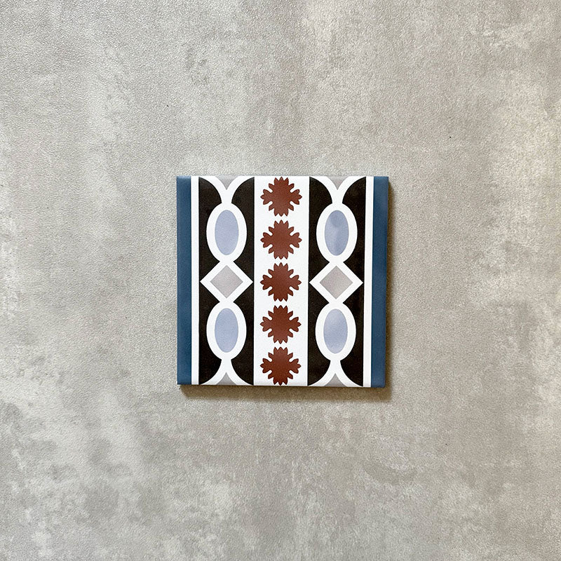 Single Imperial Victorian Blue Mini Border Tile, 15x15cm porcelain tile featuring a classic Victorian-inspired border pattern in blue, black, white, and terracotta tones, photographed on a neutral background.