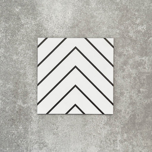 Single Almeria Jilani White Moroccan-style porcelain tile featuring a clean black line chevron pattern on a white base, 20x20cm, suitable for wall and floor use.