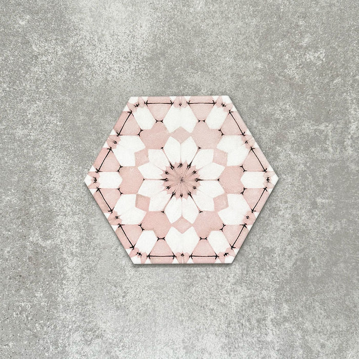 Single Medina Dusty Pink Moroccan-style hexagon porcelain tile, 18.7 × 21.6 cm, featuring a soft geometric pattern in dusty pink and white tones on a neutral background.