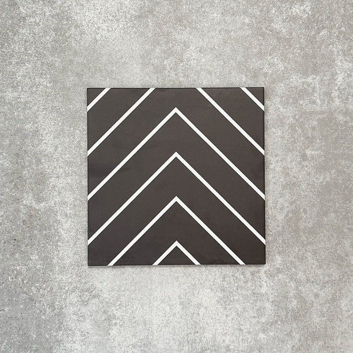 Single Almeria Jilani Black Moroccan-style porcelain tile featuring a crisp white line chevron pattern on a black base, 20x20cm, suitable for wall and floor use.