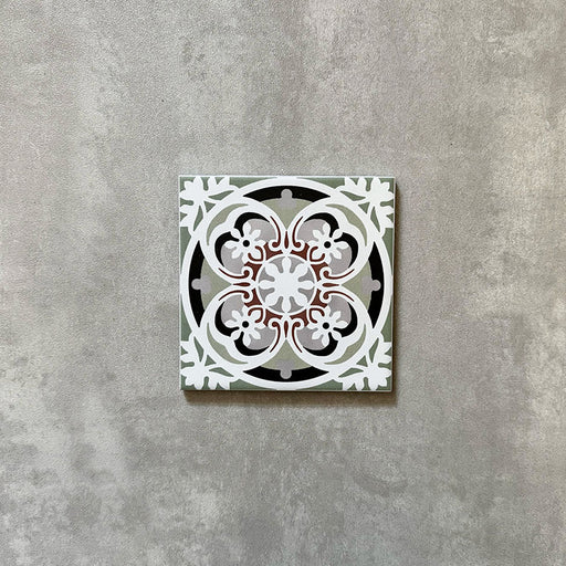 Single Imperial Victorian Green Mini Tile, 15x15cm porcelain tile featuring a classic Victorian-inspired pattern in soft green, grey, white, and terracotta tones, photographed on a neutral background.