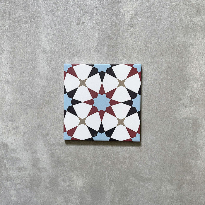 Agadir Atlas Mini Moroccan-style 15x15cm porcelain tile featuring a geometric star pattern in soft blue, burgundy, black and cream, shown as a single tile on a neutral background.