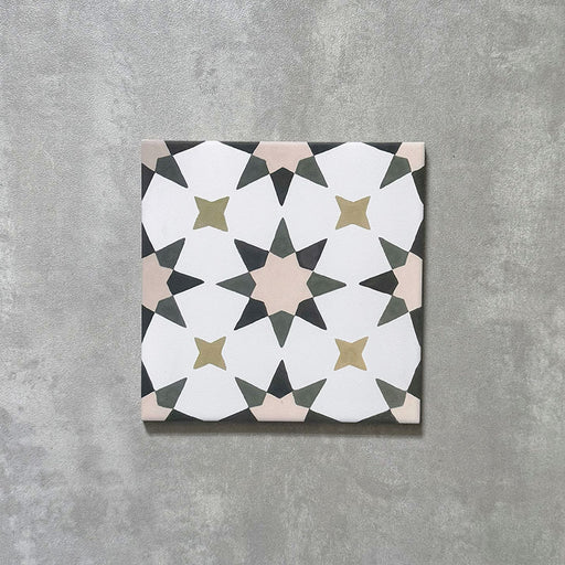 Single Agadir Natural Moroccan-style 20x20cm porcelain tile, featuring a soft neutral geometric star pattern in white with muted beige, olive and charcoal accents on a textured surface.