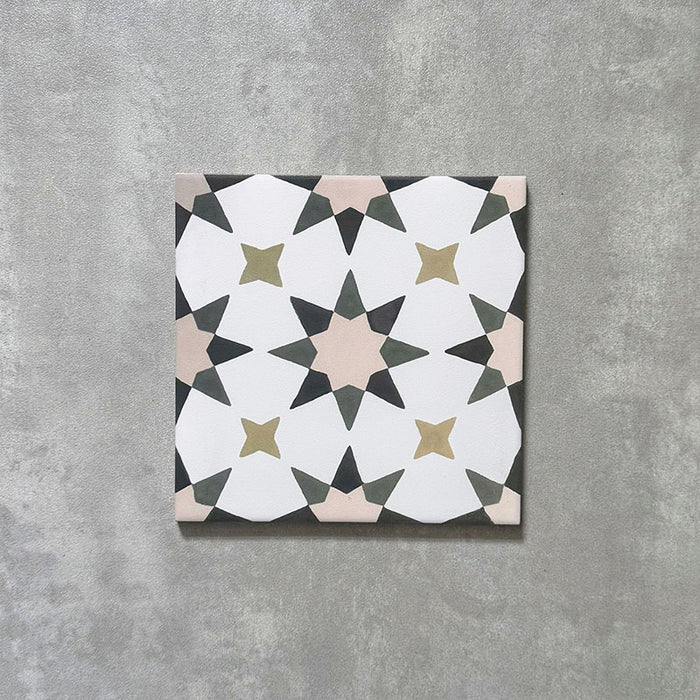 Single Agadir Natural Moroccan-style 20x20cm porcelain tile, featuring a soft neutral geometric star pattern in white with muted beige, olive and charcoal accents on a textured surface.