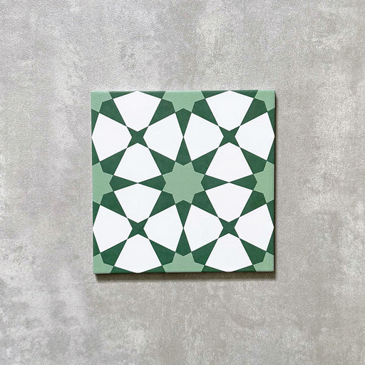 Agadir Green Moroccan-style 20x20cm porcelain tile featuring a geometric star pattern in soft green and white, shown as a single tile on a neutral background.