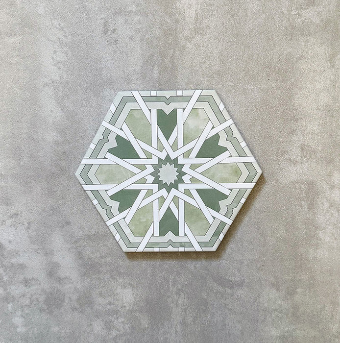 Single Medina Hormuz Verde Green Moroccan-style hexagon porcelain tile, 18.7 × 21.6 cm, featuring a bold star-inspired geometric pattern in green and white tones on a neutral background.