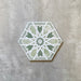 Single Medina Hormuz Verde Green Moroccan-style hexagon porcelain tile, 18.7 × 21.6 cm, featuring a bold star-inspired geometric pattern in green and white tones on a neutral background.
