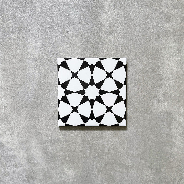 Agadir Black & White Mini Moroccan-style 15x15cm porcelain tile featuring a bold geometric star pattern in black and white, shown as a single tile on a neutral background.