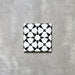 Agadir Black & White Mini Moroccan-style 15x15cm porcelain tile featuring a bold geometric star pattern in black and white, shown as a single tile on a neutral background.