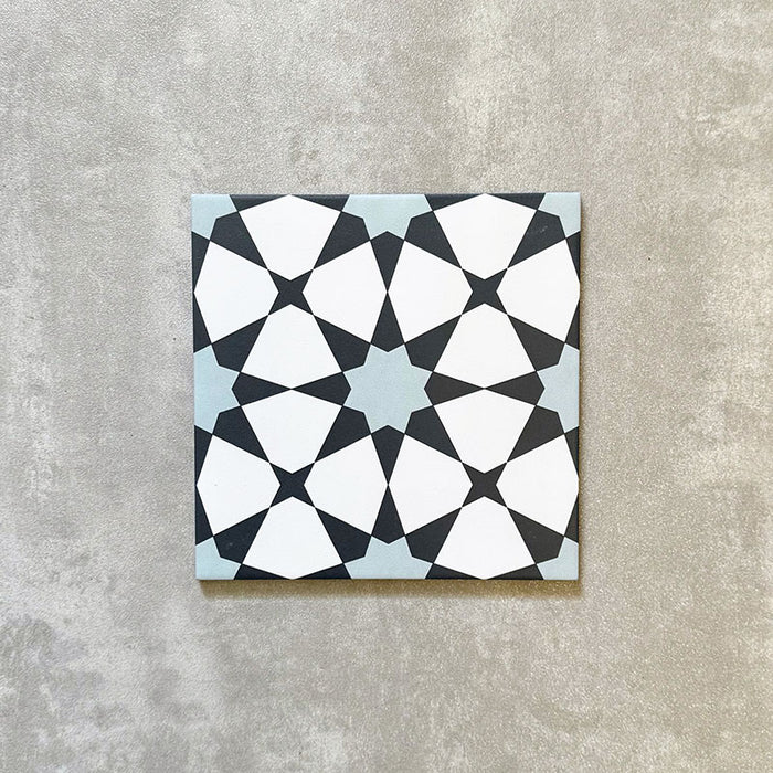 Agadir Azul Blue Moroccan-style 20x20cm porcelain tile featuring a geometric star pattern in blue, black and white, shown as a single tile on a neutral background.