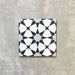 Agadir Azul Blue Moroccan-style 20x20cm porcelain tile featuring a geometric star pattern in blue, black and white, shown as a single tile on a neutral background.